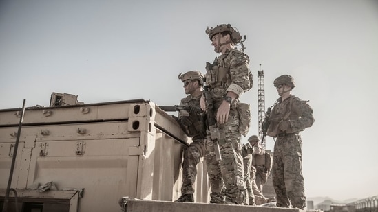 US service members assist at an Evacuation Control Check Point (ECC) during an evacuation at the Hamid Karzai International Airport in Kabul, Afghanistan, on August 26, 2021. (US Marine Corps/Staff Sgt. Victor Mancilla / Handout via REUTERS)