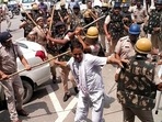 Police cane-charge farmers at Karnal's Bastara toll plaza during a protest against the new agri laws on Saturday. (Manoj Dhaka/HT) Police cane-charge farmers at Karnal's Bastara toll plaza during a protest against the new agri laws on Saturday. (Manoj Dhaka/HT)