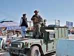 A Taliban Badri fighter stands guard at the main entrance gate of Kabul airport. (AFP) A Taliban Badri fighter stands guard at the main entrance gate of Kabul airport. (AFP)