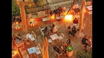 It’s better to eat far apart but it is best to eat outdoors or at places with very high ceilings It’s better to eat far apart but it is best to eat outdoors or at places with very high ceilings