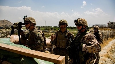 US Marines and German service members watch an entry gate during an evacuation at Hamid Karzai International Airport, in Kabul, Afghanistan, on August 28, 2021. (Photo via REUTERS)