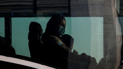 Afghan refugees sit in a bus taking them to a processing center upon arrival at Dulles International Airport in Dulles, Virginia, US, on August 28, 2021. (REUTERS)