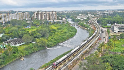A metro train ply near the Vrishabhavathi river during the inauguration of 7.5 km segment of Bengaluru Metro Purple Line on Sunday. (PTI) A metro train ply near the Vrishabhavathi river during the inauguration of 7.5 km segment of Bengaluru Metro Purple Line on Sunday. (PTI)