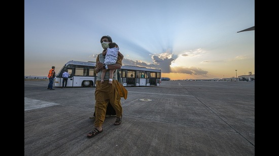 An evacuee from Afghanistan boards a US-bound flight. (REUTERS)
