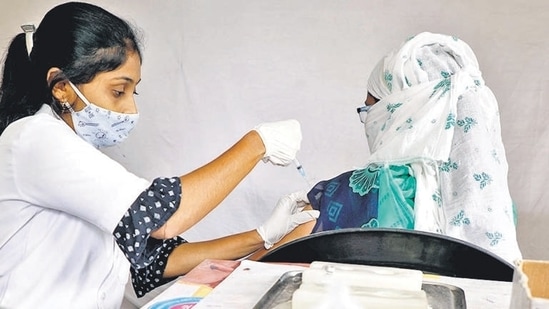 A health worker administers the Covid-19 vaccine to a beneficiary at a vaccination centre in Katraj on Friday. (HT PHOTO)