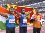 Indian athletes silver medalist Devendra Jhajharia (R) and bronze medalist Sundar Singh Gurjar (L) with gold medalist Sri Lanka's Dinesh Priyantha