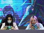 People play mobile games at a booth at the China Digital Entertainment Expo and Conference, also known as ChinaJoy, in Shanghai(REUTERS) People play mobile games at a booth at the China Digital Entertainment Expo and Conference, also known as ChinaJoy, in Shanghai(REUTERS)
