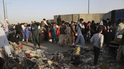 Hundreds of people gather near a checkpoint at Hamid Karzai International Airport, in Kabul, Afghanistan on August 25, 2021. In Afghanistan, India invested over a billion dollars to build a democratic State. None of this would have been possible without Afghan partners. From Kabul to Kandahar, India deployed paramilitary forces that relied on locals for support and security. (AP)