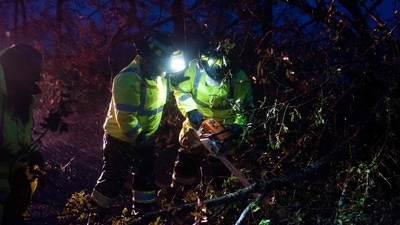 Montegut and Bourg firefighters cut through trees on the road in Bourg, Louisiana as Hurricane Ida passes on August 29. Ida struck New Orleans on the 16th anniversary of Hurricane Katrina, the costliest tropical cyclone in US history that left much of the city in ruins. (Mark Felix / AFP) Montegut and Bourg firefighters cut through trees on the road in Bourg, Louisiana as Hurricane Ida passes on August 29. Ida struck New Orleans on the 16th anniversary of Hurricane Katrina, the costliest tropical cyclone in US history that left much of the city in ruins. (Mark Felix / AFP)