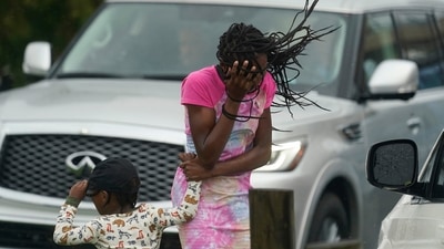 A woman and a child hold on amid strong winds and rain caused by Hurricane Ida, in New Orleans, on August 29. Ida’s 150-mile-per-hour winds tie Louisiana’s hurricane record set by Laura in 2020 and a 19th century storm, Bloomberg reported. (AP / PTI) A woman and a child hold on amid strong winds and rain caused by Hurricane Ida, in New Orleans, on August 29. Ida’s 150-mile-per-hour winds tie Louisiana’s hurricane record set by Laura in 2020 and a 19th century storm, Bloomberg reported. (AP / PTI)