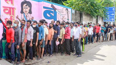 Beneficiaries not adhering to social distancing norms, wait in a queue to receive Covid-19 vaccine dose, at a government school turned vaccination centre at Shivaji Nagar in Gurugram on Monday. (PTI) Beneficiaries not adhering to social distancing norms, wait in a queue to receive Covid-19 vaccine dose, at a government school turned vaccination centre at Shivaji Nagar in Gurugram on Monday. (PTI)