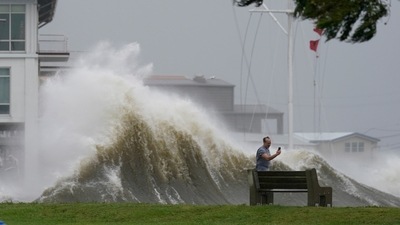 A man takes pictures of high waves along the shore of Lake Pontchartrain in New Orleans on August 29. More than 1 million homes and businesses in Louisiana and about 100,000 in Mississippi were without power on August 29, according to Poweroutage.us. (Gerald Herbert / AP) A man takes pictures of high waves along the shore of Lake Pontchartrain in New Orleans on August 29. More than 1 million homes and businesses in Louisiana and about 100,000 in Mississippi were without power on August 29, according to Poweroutage.us. (Gerald Herbert / AP)