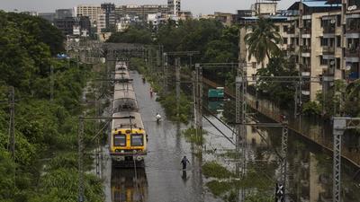 Commuters walk on the flooded railway track near Tilak Nagar station in Mumbai in July. Mumbai is one of the most vulnerable cities to the climate crisis-induced hazards such as sea-level rise, storm surge and urban flooding. These extreme weather events are only going to increase in the future. (HT Archive) Commuters walk on the flooded railway track near Tilak Nagar station in Mumbai in July. Mumbai is one of the most vulnerable cities to the climate crisis-induced hazards such as sea-level rise, storm surge and urban flooding. These extreme weather events are only going to increase in the future. (HT Archive)
