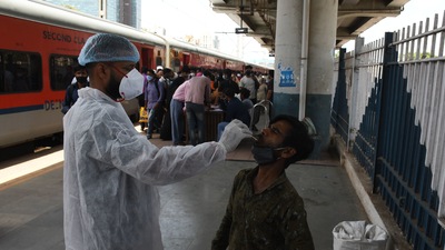 A BMC health worker collects swab samples for Covid-19 test of commuters arriving from outstation trains at Dadar station, in Mumbai. (Bhushan Koyande/ HT Photo) A BMC health worker collects swab samples for Covid-19 test of commuters arriving from outstation trains at Dadar station, in Mumbai. (Bhushan Koyande/ HT Photo)