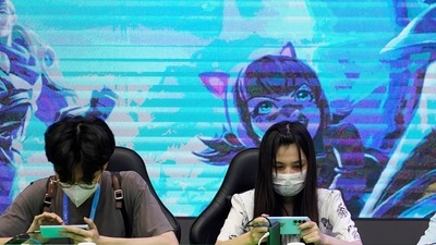 People play mobile games at a booth at the China Digital Entertainment Expo and Conference, also known as ChinaJoy, in Shanghai (REUTERS) People play mobile games at a booth at the China Digital Entertainment Expo and Conference, also known as ChinaJoy, in Shanghai (REUTERS)
