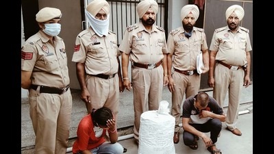 The accused and the cannabis seized from them in custody of Doraha police on Monday. (HT )