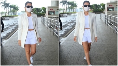 To accessorise the ensemble, Parineeti chose patterned gold hoop earrings and tinted sunglasses. She also wore an ivory printed face mask to keep herself safe for her flight out of the bay. (HT Photo/Varinder Chawla)