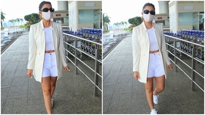 Parineeti completed her jet-set ensemble with a pair of white-coloured denim shorts and white Prada lace-up chunky sneakers. She added a pop of colour with neon green nail paint. (HT Photo/Varinder Chawla)
