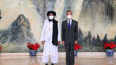 Taliban leader Mullah Abdul Gani Baradar with Chinese foreign minister Wang Yi.