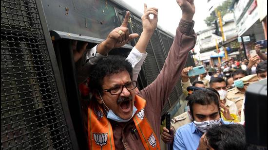 Police detain BJP workers after they protest against Maharashtra government demanding reopening of temples as part of their statewide agitation amid Covid curbs, at Kandivli in Mumbai on Monday. (HT PHOTO)