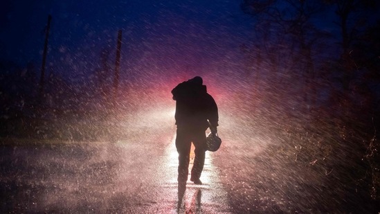 Montegut fire chief Toby Henry walks back to his fire truck in the rain in Bourg, Louisiana on August 29. The storm was responsible for at least one death, as the Louisiana health department said a man in Ascension Parish was killed when a tree fell on his home.(Mark Felix / AFP)