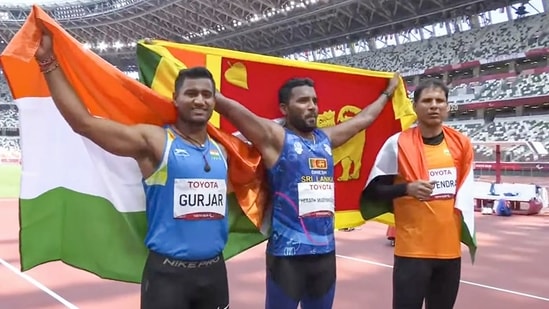 Indian athletes silver medalist Devendra Jhajharia (R) and bronze medalist Sundar Singh Gurjar (L) with gold medalist Sri Lanka's Dinesh Priyantha(PTI) Indian athletes silver medalist Devendra Jhajharia (R) and bronze medalist Sundar Singh Gurjar (L) with gold medalist Sri Lanka's Dinesh Priyantha(PTI)