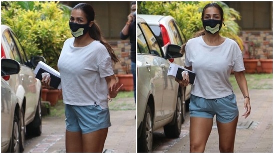 Malaika wore a textured white top with a low-high hemline for her yoga routine. The model and actor teamed it with powder blue mini shorts and flaunted her enviable curves.(HT Photo/Varinder Chawla)
