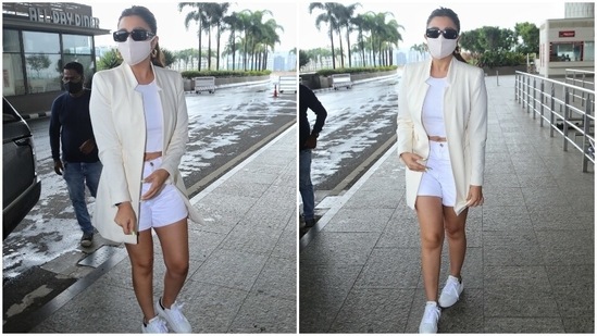 Parineeti wore a long tailored ivory blazer featuring raised notch lapel collar, an open front and faux pockets on both sides. She teamed the blazer with a crew neck crop top and hinted at her midriff.(HT Photo/Varinder Chawla)