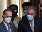 Pakistan's foreign minister Shah Mahmood Qureshi (R) arrives with German foreign minister Heiko Maas for a joint a press conference after their meeting to discuss the current situation in Afghanistan, in Islamabad