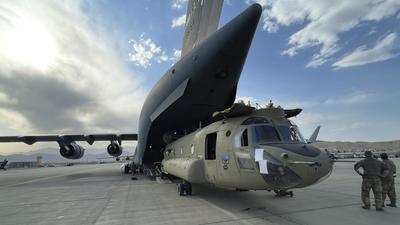 A CH-47 Chinook from the 82nd Combat Aviation Brigade, 82nd Airborne Division is loaded onto a US Air Force C-17 Globemaster III at Hamid Karzai International Airport in Kabul, Afghanistan. (AP)