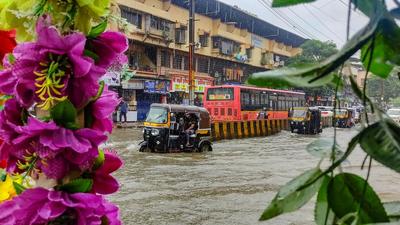 Vehicles wade through a waterlogged road after heavy rain at Nallasopara in Palghar district on Tuesday. (PTI) Vehicles wade through a waterlogged road after heavy rain at Nallasopara in Palghar district on Tuesday. (PTI)