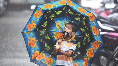 A child looks on as Govindas attempt to break a dahi handi on the occasion of Gokulashtami festival, amid heavy downpour at Vile Parle. (Satish Bate/HT PHOTO) A child looks on as Govindas attempt to break a dahi handi on the occasion of Gokulashtami festival, amid heavy downpour at Vile Parle. (Satish Bate/HT PHOTO)