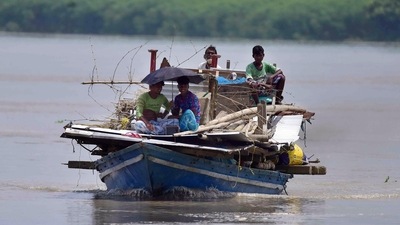 Locals transport their belongings through a boat at a flooded village, in Morigaon. (ANI) Locals transport their belongings through a boat at a flooded village, in Morigaon. (ANI)