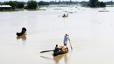 Locals row their boats with their belongings to move to a safer place after the floodwater enters the village amid heavy rainfall, in Morigaon. (ANI) Locals row their boats with their belongings to move to a safer place after the floodwater enters the village amid heavy rainfall, in Morigaon. (ANI)