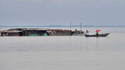 A villager rows a boat next to a partially submerged hut in a flood affected area of Morigaon district in Assam. (AFP) A villager rows a boat next to a partially submerged hut in a flood affected area of Morigaon district in Assam. (AFP)