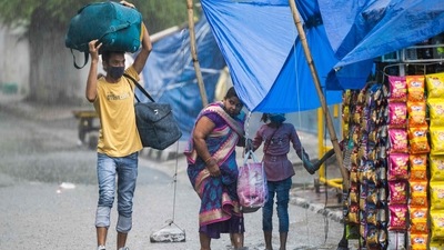 People walk along a waterlogged street during heavy rain in New Delhi on August 31. (AFP) People walk along a waterlogged street during heavy rain in New Delhi on August 31. (AFP)