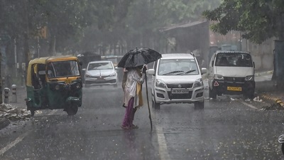 A man with an umbrella crosses the road amid heavy rain in New Delh on August 31. (PTI) A man with an umbrella crosses the road amid heavy rain in New Delh on August 31. (PTI)