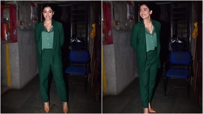 Rashmika wore a notch lapel tailored blazer in a dark green hue, featuring faux pockets on both sides and long sleeves. She teamed it with coordinated high waist straight-fit pants and looked elegant. (HT Photo/Varinder Chawla)