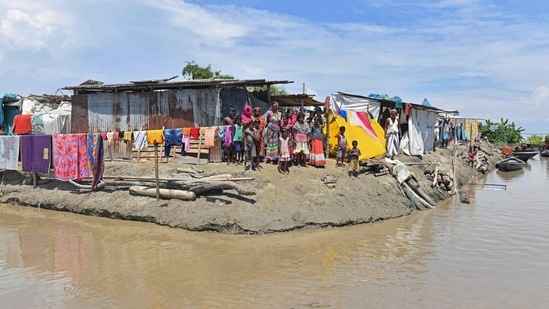 Villagers take shelter on higher grounds in a flood affected area of Morigaon district in Assam.(AFP)