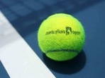An Australian Open branded tennis ball is seen on court. An Australian Open branded tennis ball is seen on court.