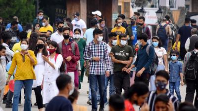 Tourists and the local crowd enjoying a stroll on The Ridge in Shimla on Sunday. (Deepak Sansta/HT)