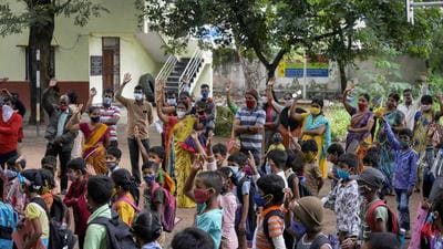 Students assemble before entering their respective classes at the premises of a government school in Hyderabad on Wednesday after the state government relaxed the Covid-19 coronavirus lockdown norms for educational institutions, allowing students to attend physical classes. (AFP) Students assemble before entering their respective classes at the premises of a government school in Hyderabad on Wednesday after the state government relaxed the Covid-19 coronavirus lockdown norms for educational institutions, allowing students to attend physical classes. (AFP)