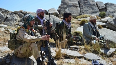 Afghan resistance movement and anti-Taliban uprising forces take rest as they patrol on a hilltop in Darband area in Anaba district, Panjshir province. (AFP)