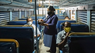 A lady conductor issues tickets to customer during start of Kerala RTC services, after relaxations in COVID-19 lockdown, in Kozhikode. (PTI Photo)