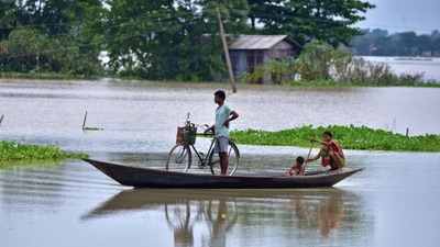 (Top) People travel in a boat through a flooded field in Assam’s Morigaon district on Wednesday. (Above) The roof of a house collapsed due to a landslide after heavy rainfall in Thane. Reuters (Top) People travel in a boat through a flooded field in Assam’s Morigaon district on Wednesday. (Above) The roof of a house collapsed due to a landslide after heavy rainfall in Thane. Reuters