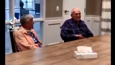 The image shows the WWII veteran sitting with his wife. (Twitter/@travisakers)