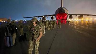 Paratroopers assigned to the 82nd Airborne Division board a US Air Force C-17 to leave Hamid Karzai International Airport in Kabul, Afghanistan on Monday. (REUTERS)