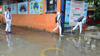 Students wade through a waterlogged stretch after heavy rain at Sarvodaya Vidyalaya in Deen Dayal Upadhaya Marg, on Wednesday. (Raj K Raj/HT) Students wade through a waterlogged stretch after heavy rain at Sarvodaya Vidyalaya in Deen Dayal Upadhaya Marg, on Wednesday. (Raj K Raj/HT)
