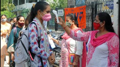 Students of Government College, Mandi, undergoing thermal scanning before entering their college on Wednesday. (Birbal Sharma/HT) Students of Government College, Mandi, undergoing thermal scanning before entering their college on Wednesday. (Birbal Sharma/HT)