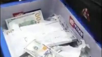 Screen grab of video showing the seized foreign currency. (TWITTER/CISF.) Screen grab of video showing the seized foreign currency. (TWITTER/CISF.)